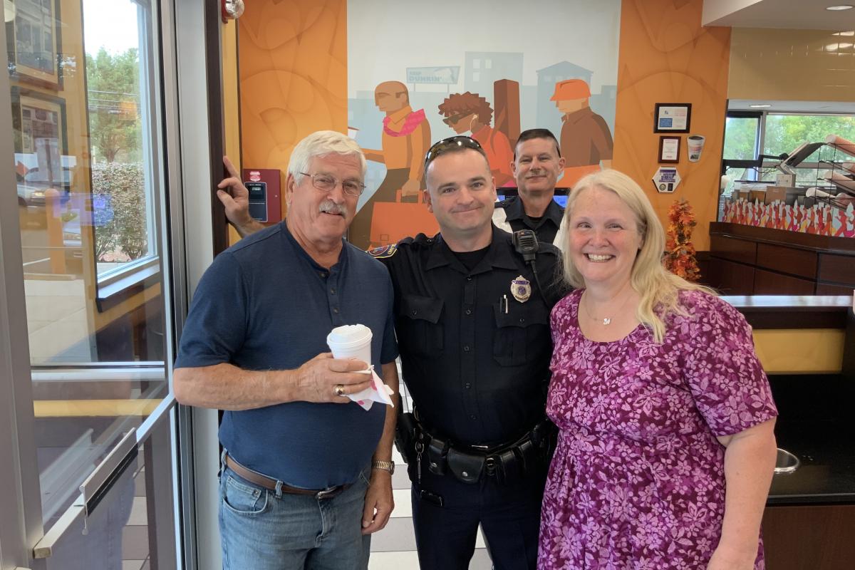 Two officers at Dunkin Donuts with two citizens